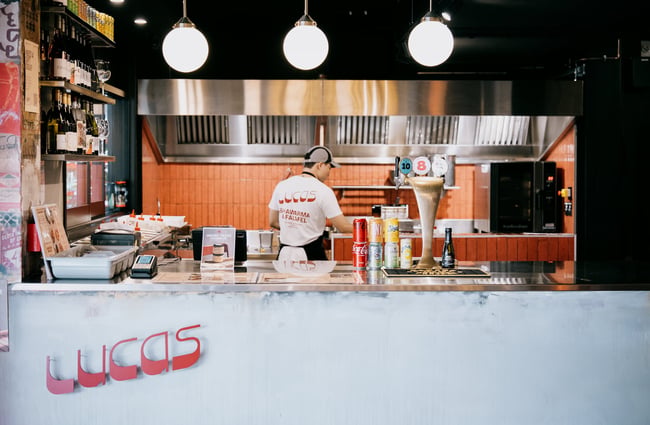 Worker standing behind counter of Lucas at Little High Eatery in Christchurch