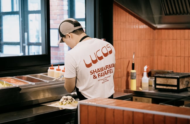 Staff member cooking in kitchen at Lucas at Little High Eatery in Christchurch