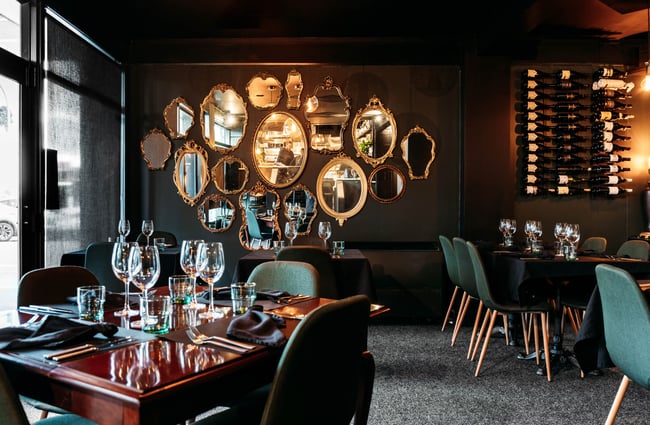 Dining room with tables and chairs set up at Lustre.