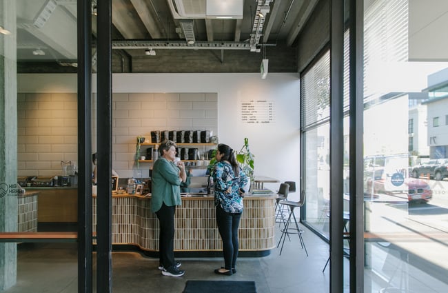 Two customers chatting at the counter.
