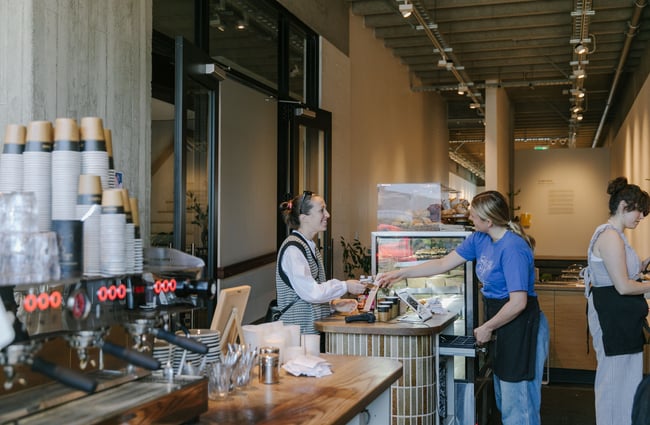 A customer smiling at a staff member at Lux.