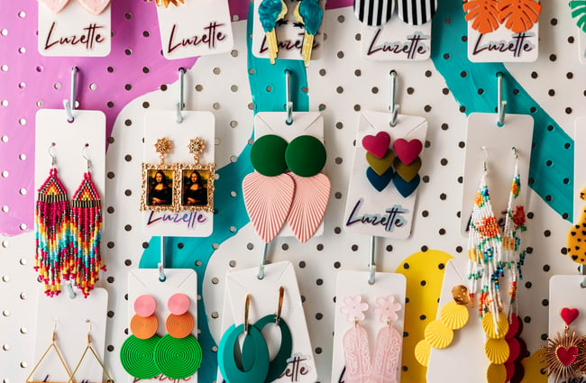 Close up of bold earrings made by Luzette