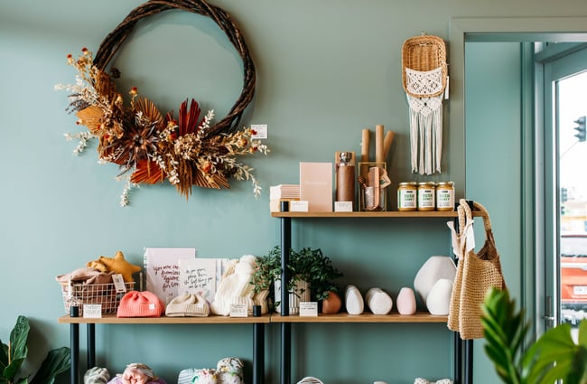 Homewares on shelves sitting against a blue wall.