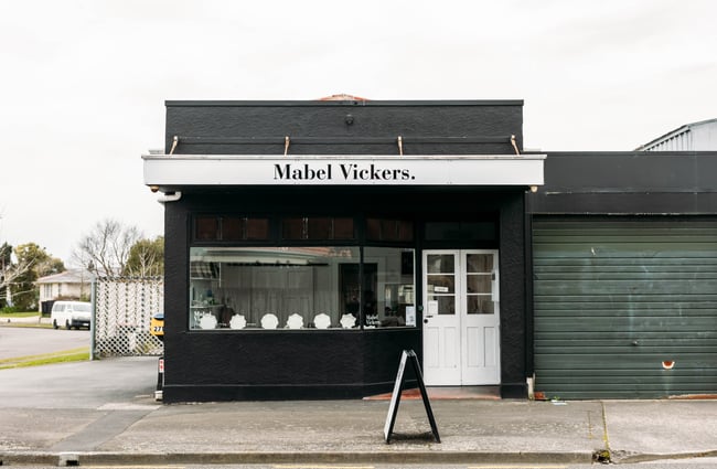 Black building on the corner of the street housing Mabel Vickers.
