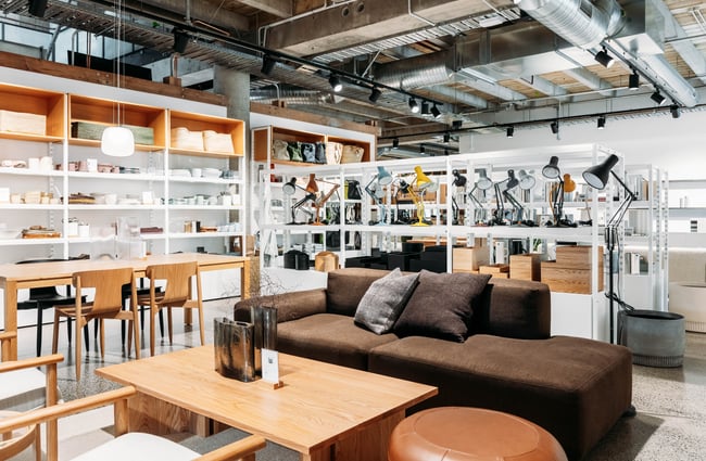 Sofa on display and other homeware items on shelves in the Citta showroom at Made.