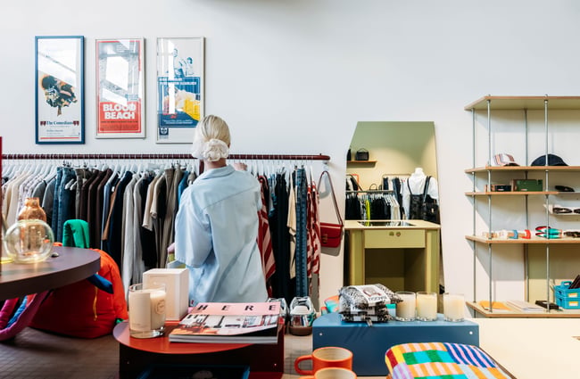 A customer looking through the clothing racks at a store in Made.