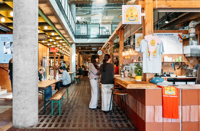 Customers standing by a food outlet placing their order at Made.