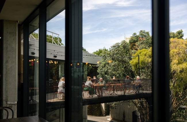 People dining upstairs on a balcony.
