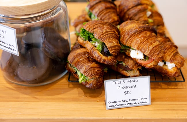 Croissants and chocolate biscuits on a counter.