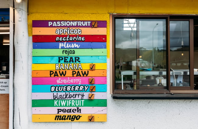 Colourful menu for the real fruit ice creams beside the window at Manakau Market.