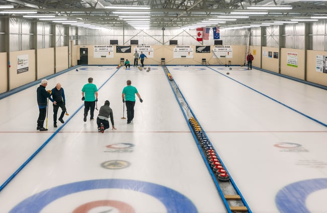 People curling on an ice rink.