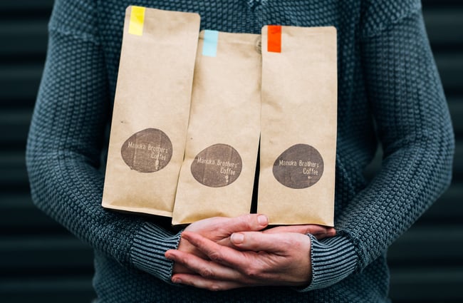 An armful of wholesale beans at Manuka Brothers, Hamilton.