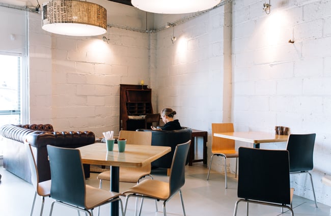 Customer amid seating at Manuka Brothers, Hamilton.