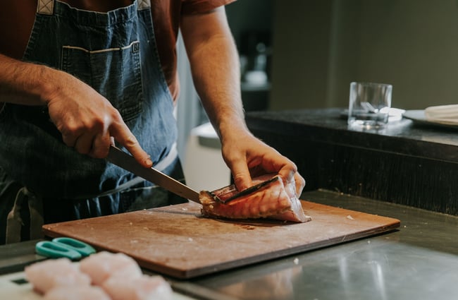 A close up of fish being sliced by Giulio.