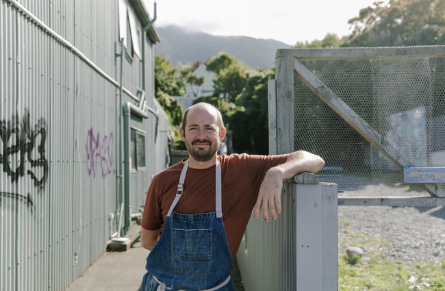 Giulio Sturla standing outside his restaurant smiling to camera.
