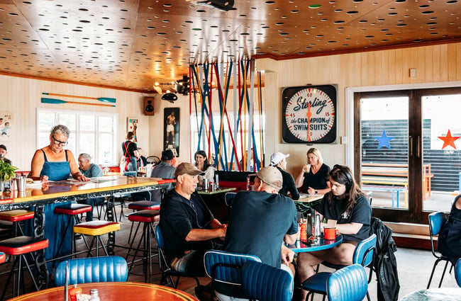 Tables full of people dining inside at Maranui Cafe in Lyall Bay Wellington