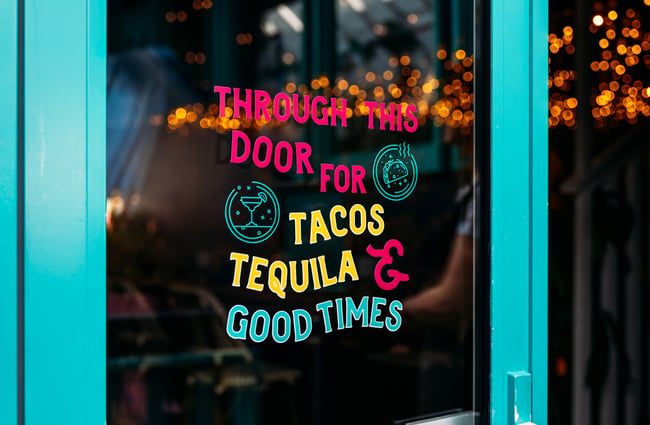 A sign promoting tacos and Mexican food.