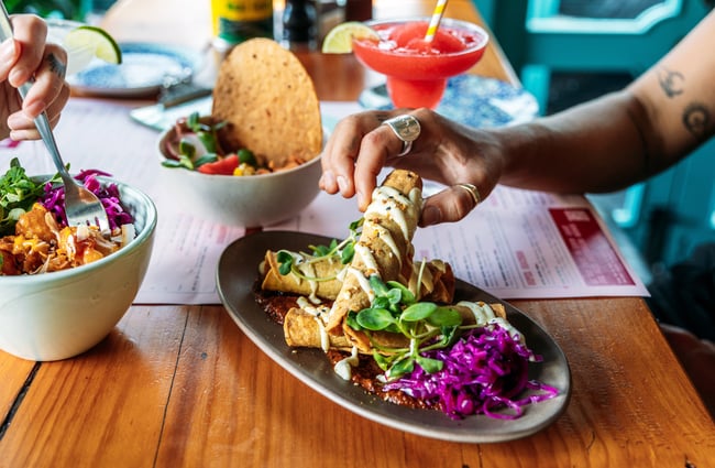 Plates of colourful Mexican food.
