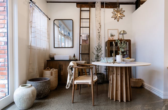 Natural coloured furniture set up in a nice display in the corner of a store.