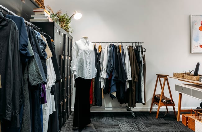 Black and white clothing on display inside a little retail store.