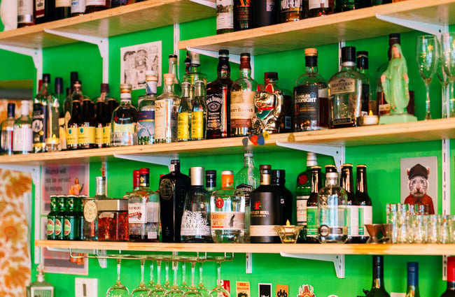 Liquor bottles behind the bar.