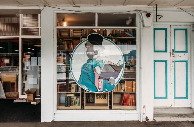 Character on window signage at Mewington's Book Shoppe.