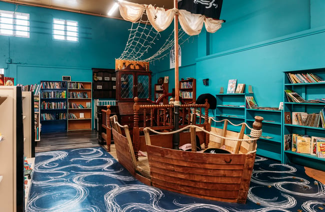 Pirate ship surrounded by bookshelves at Mewington's Book Shoppe.