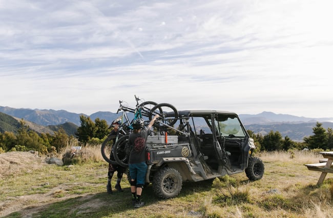 Lifting mountain bikes off a cart.