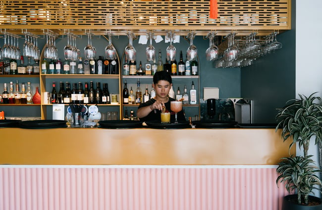 Bartender making cocktail behind bar at Midnight Shanghai in Christchurch