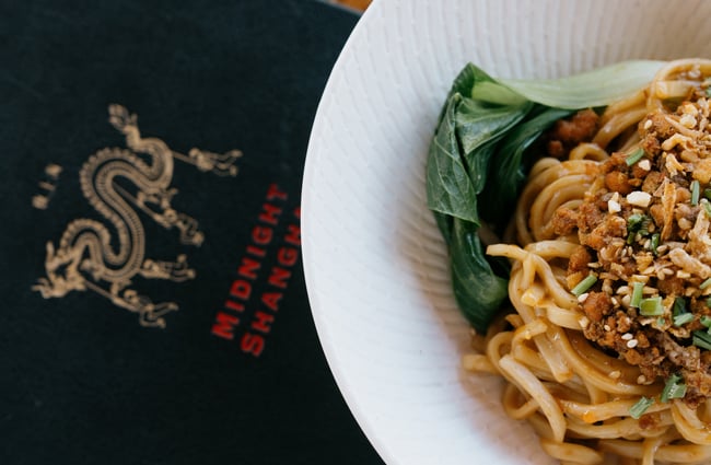 Menu detail next to bowl of noodles
