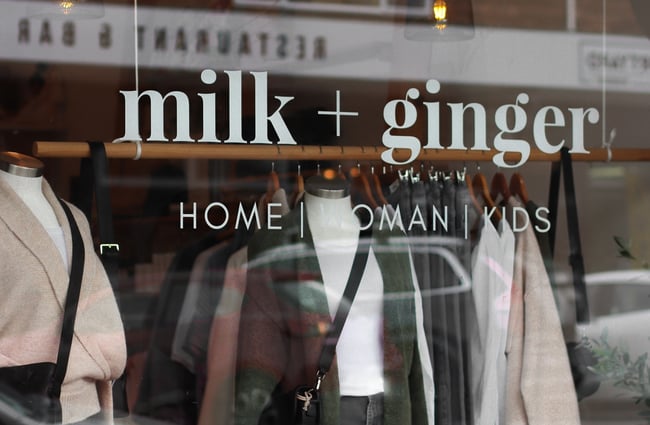 Close up of 'milk + ginger' printed on the shopfront window.