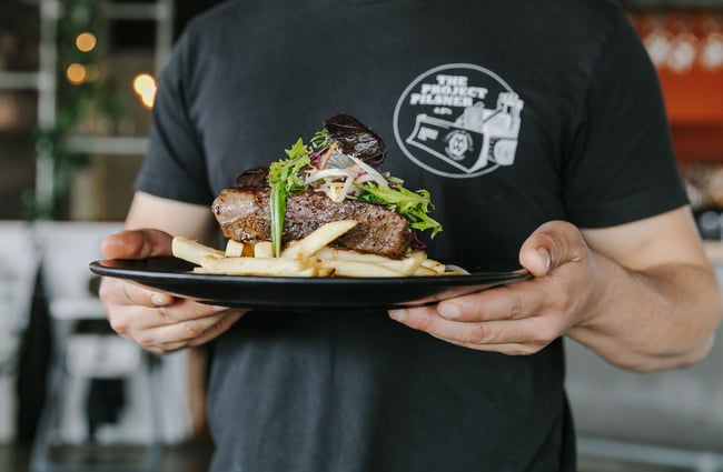 Someone holding a plate of steak and chips from Ministry of Works, Twizel.