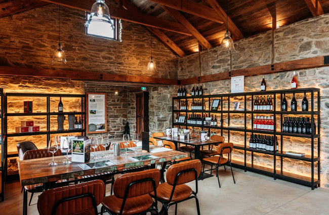 Tasting room and wine bottles on shelves at Monte Christo Winery.