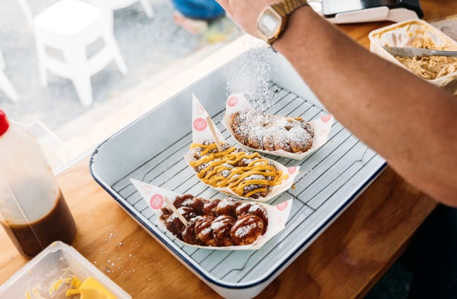 Three plates of dutch waffles being decorated.