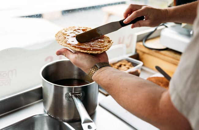 Jam being spread on to a waffle.