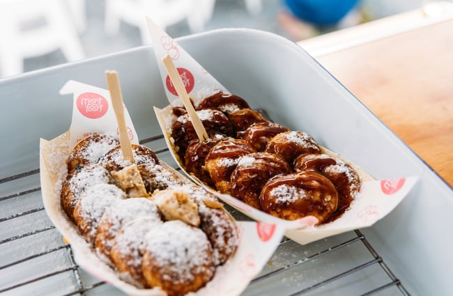 Two waffles on disposable trays.