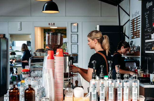 A woman making coffee at MOOMAA Cafe and Design Store in Rangitikei.