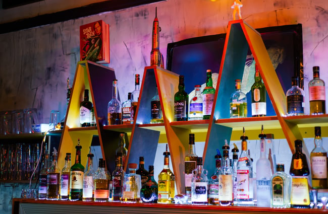Alcohol on coloured shelves inside.