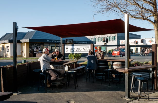 Customers sitting outside on a sunny day.