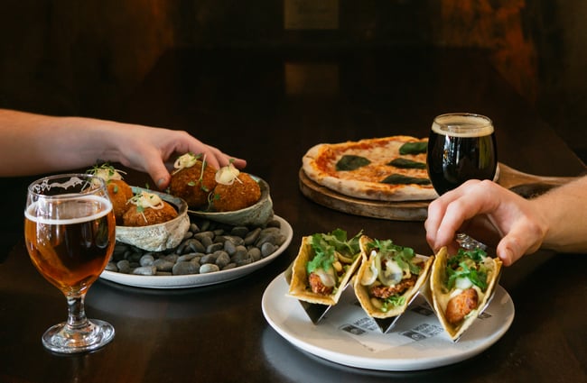 Snacks and tacos on the table at Moon Under Water.