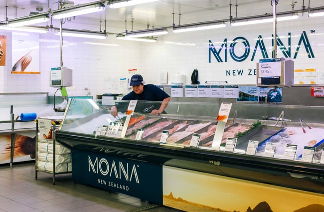 Moana mural behind lady at the fish counter.