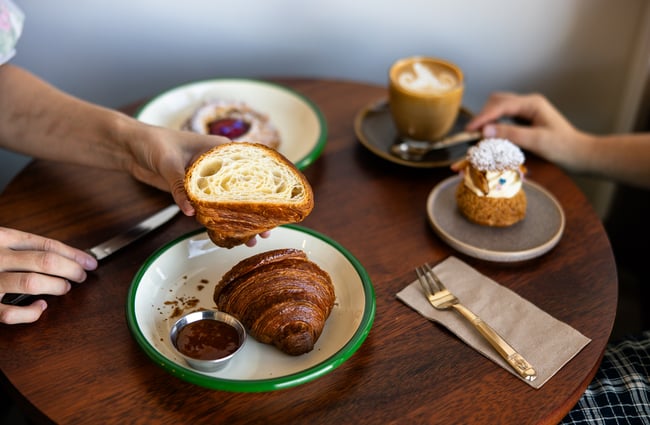 A close up of a croissant cut in half.