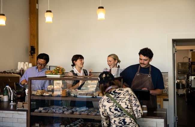 Staff members working behind a cafe counter.
