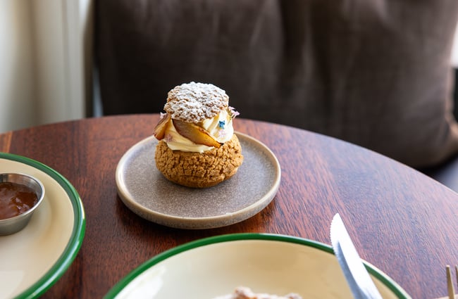 A close up of cream cake on a table.