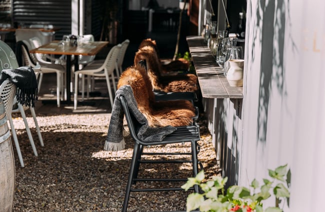 Outdoor seats covered in sheepskins.