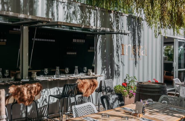 A window opening into a courtyard at Mora Wines Arrowtown.