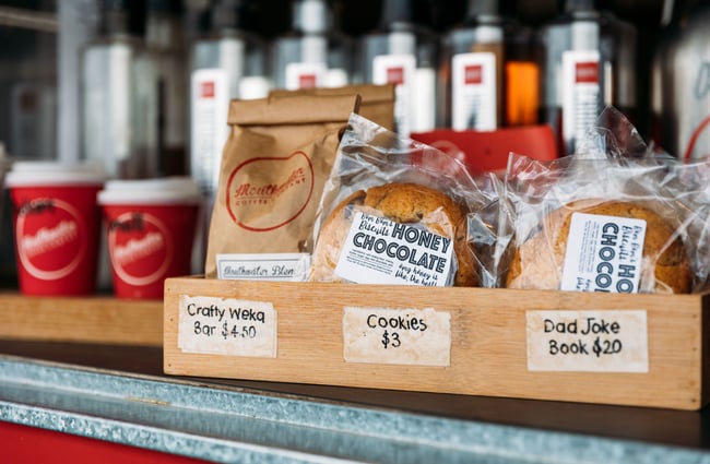 A close up of bags of coffee and biscuits.