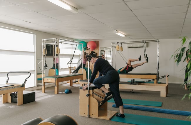 People working inside a pilates studio.