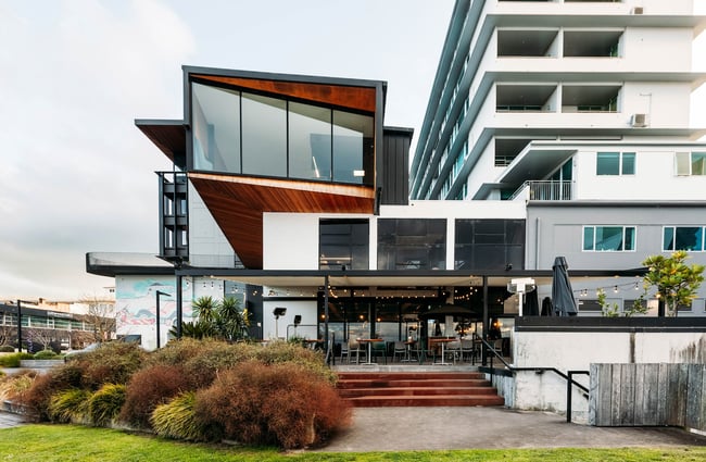 Exterior of Mr. Pickles, its covered courtyard at the base of a modern office building.