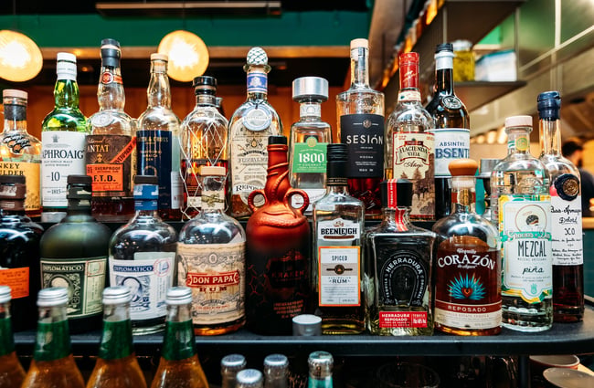 Glass bottles of spirits behind the bar at Mr. Pickles.